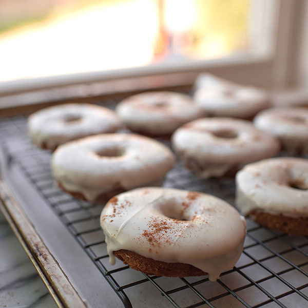 image of donuts on a cooling rack from the side.
