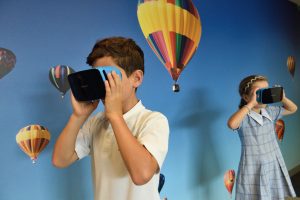 an image of a boy and a girl using virtual reality headsets.