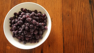 white bowl filled with frozen blueberries.