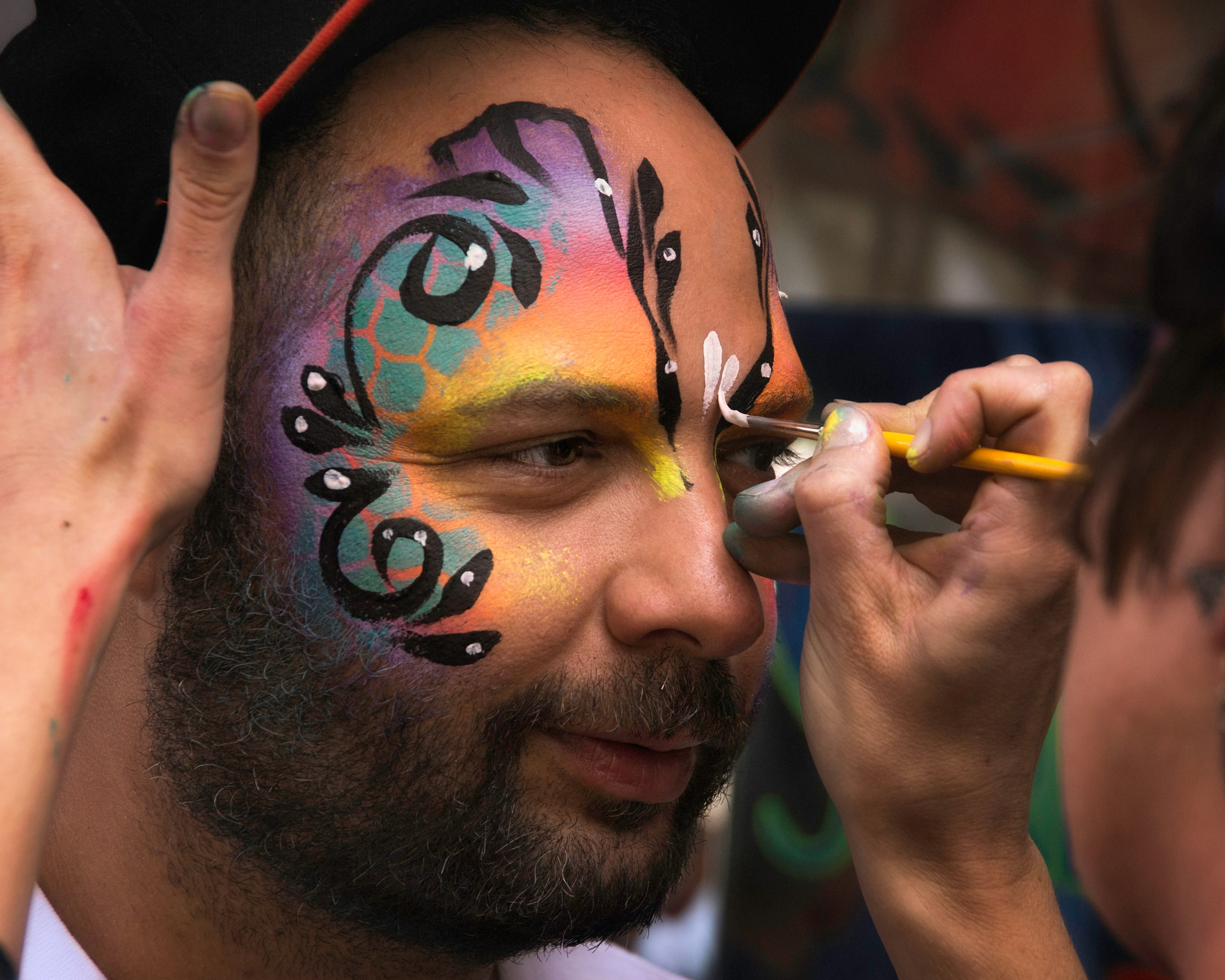 A male guest having his face painted