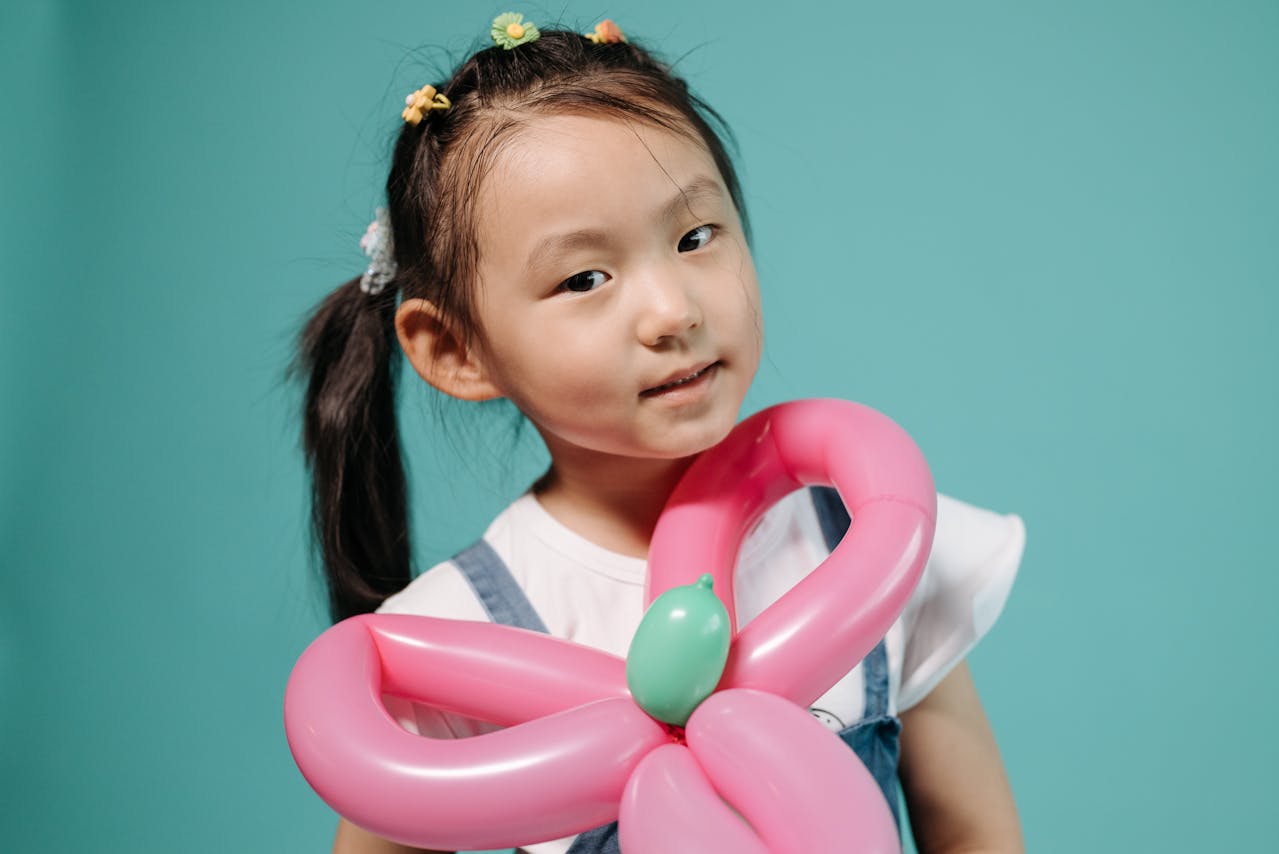 girl holding a flower balloon