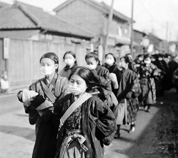 Schoolgirls wear masks to protect from the Spanish flu in Japan