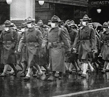 Soldiers wearing masks marching up streets in 1918/19