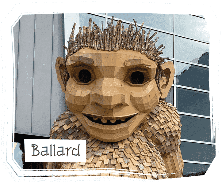 Frankie Feetsplinter, a wooden troll sculpture by Thomas Dambo, standing in a forest with a playful, whimsical design made from recycled materials, embodying the connection between art and nature.