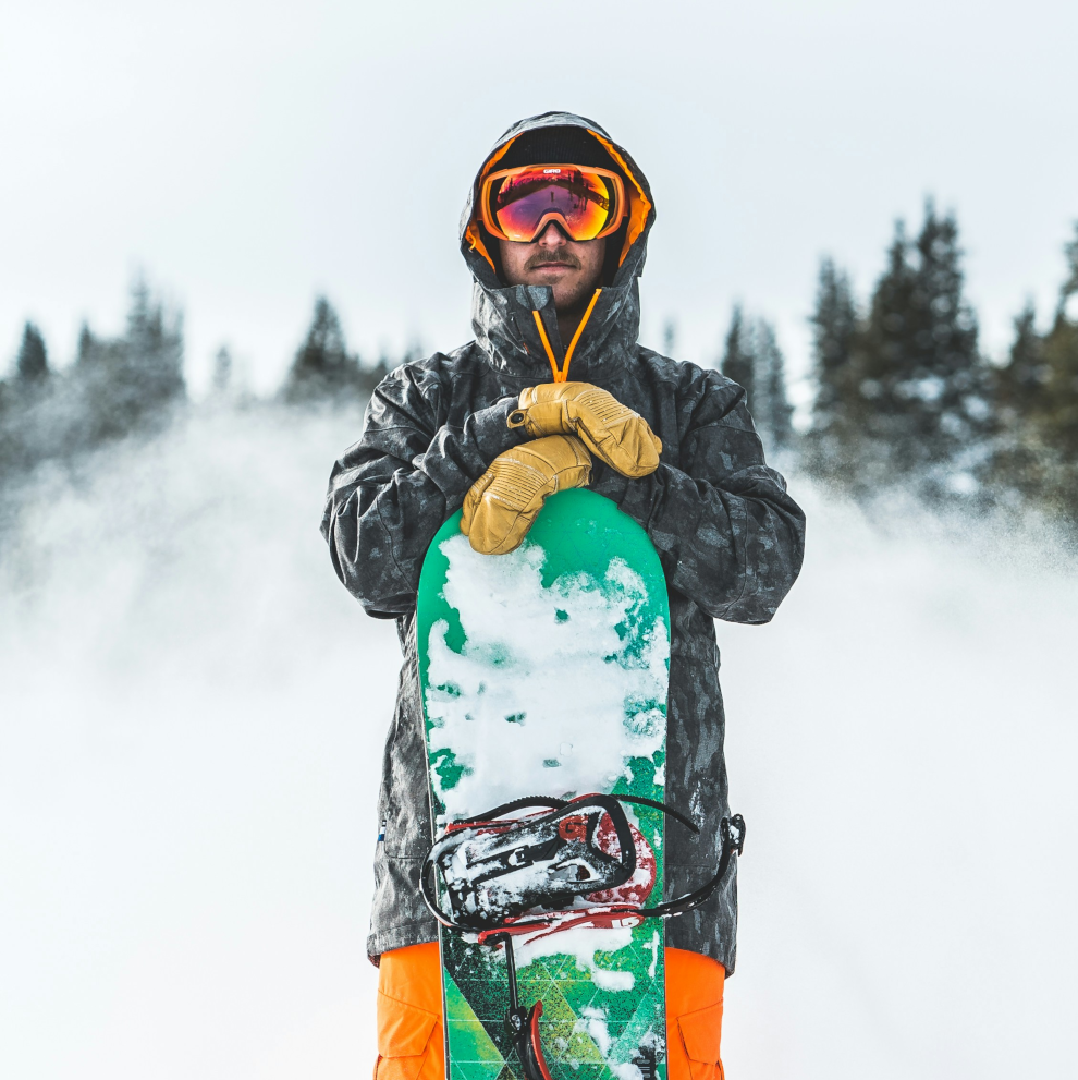 man holding a snowboard