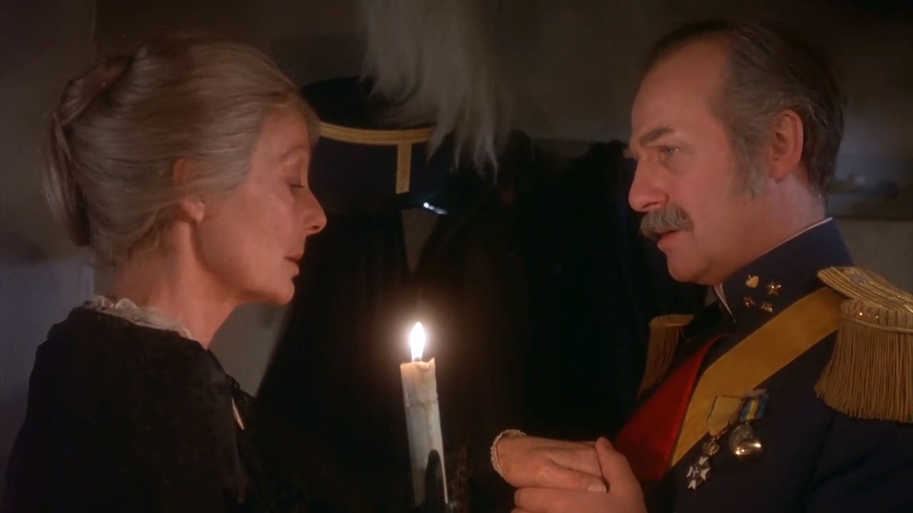 Martine and Lorens look at each other over a candle