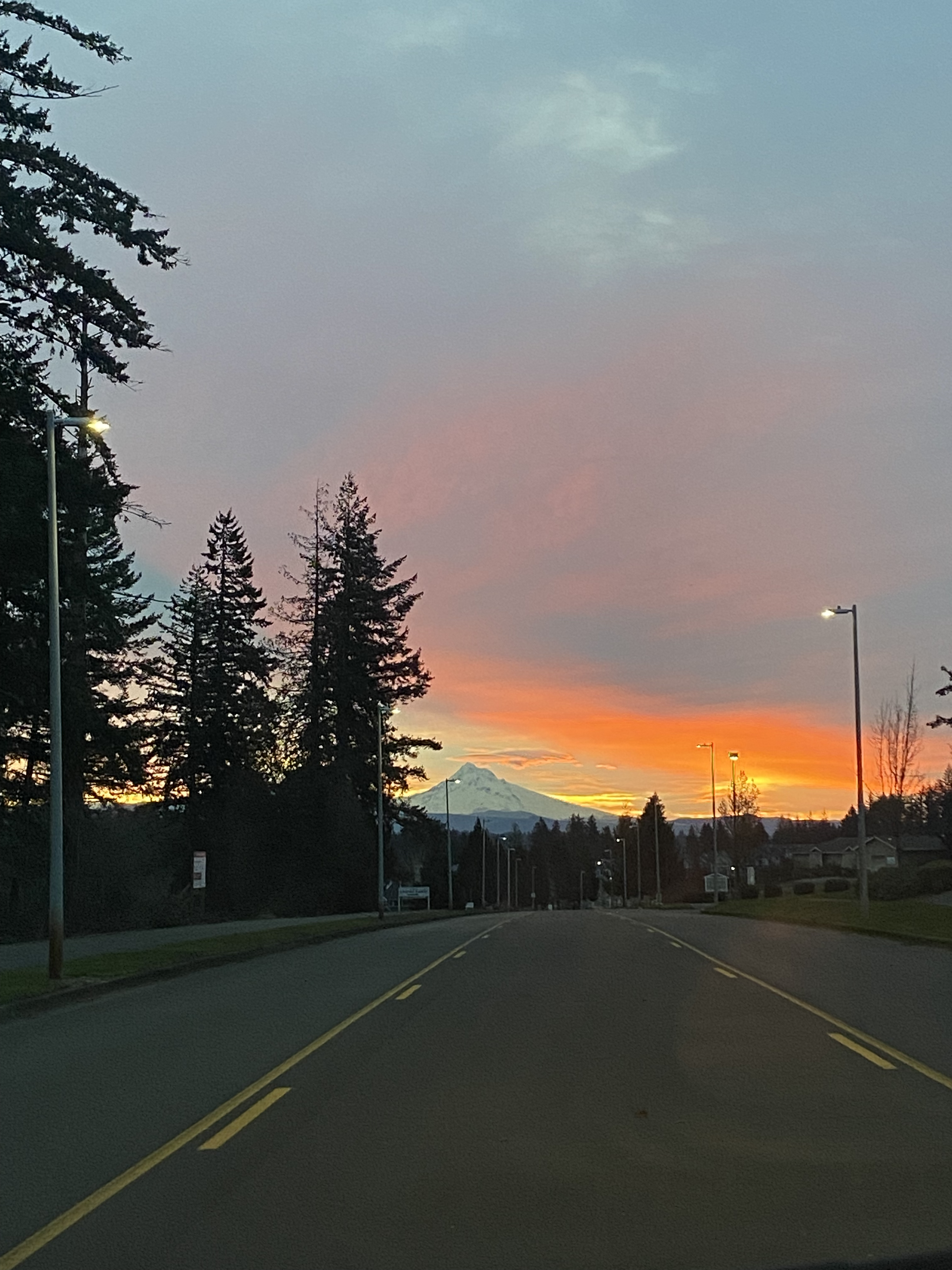 An orange sky over Mt. Hood with a road in the foreground