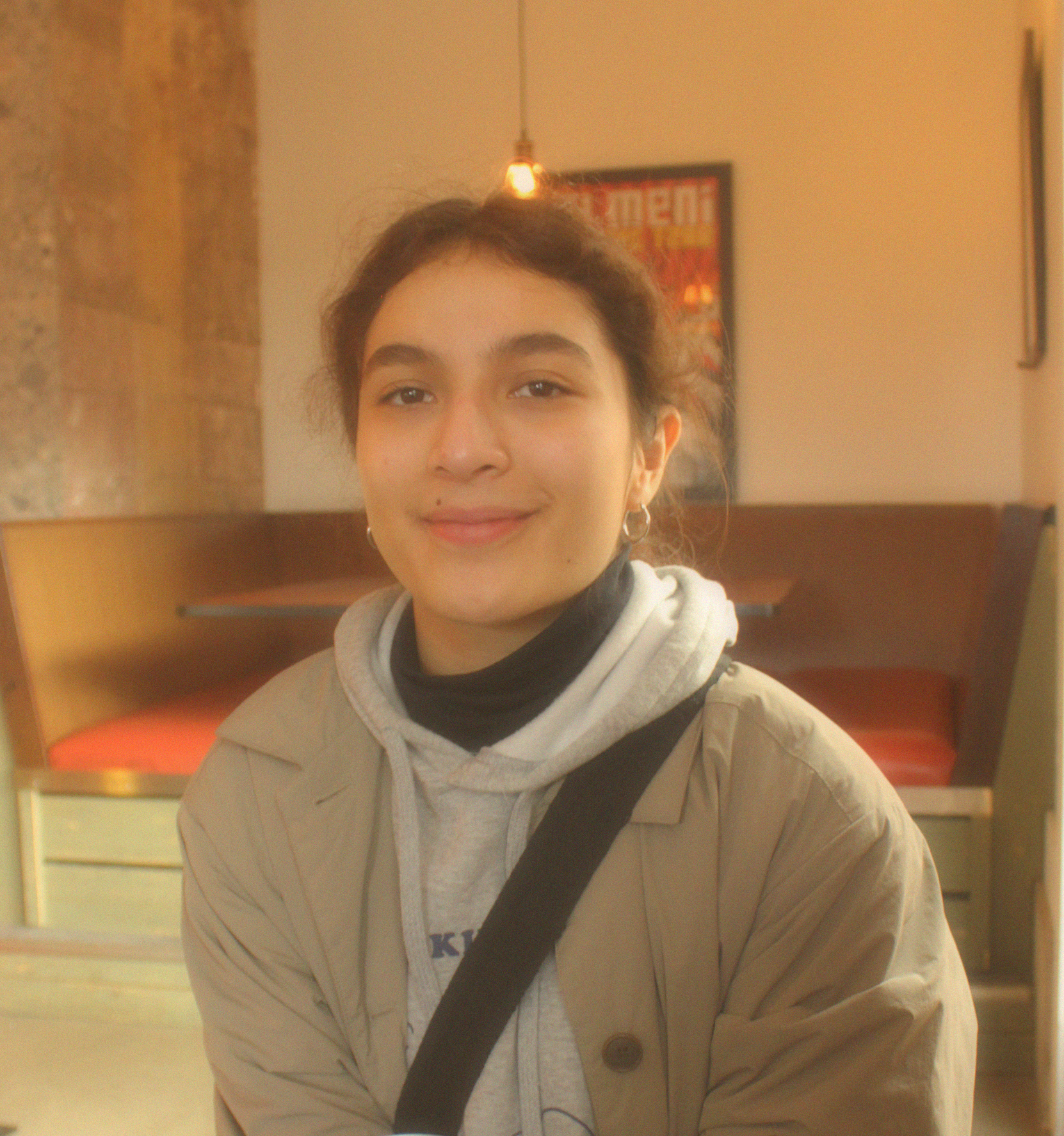 a girl smiling in a restaurant.