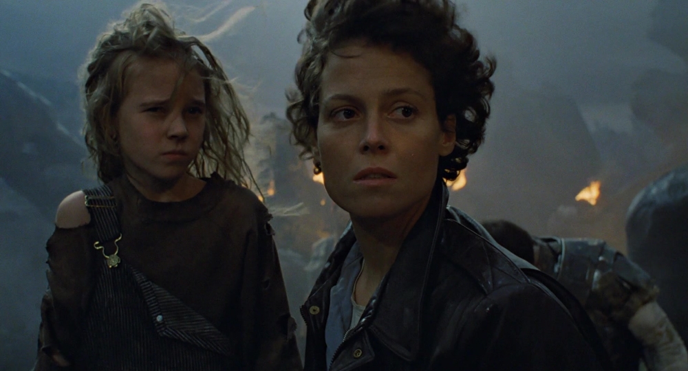 Ellen Ripely and Newt standing outside