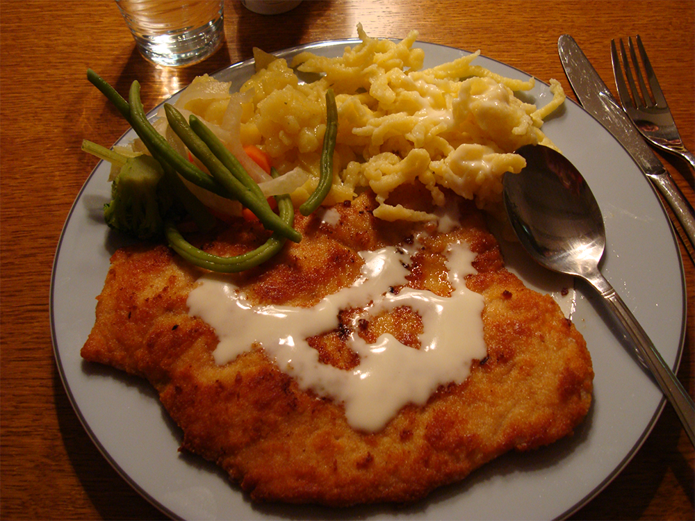 Plate of schnitzel with speatzle in the side