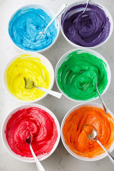 Bowls of colorful cookie icing.