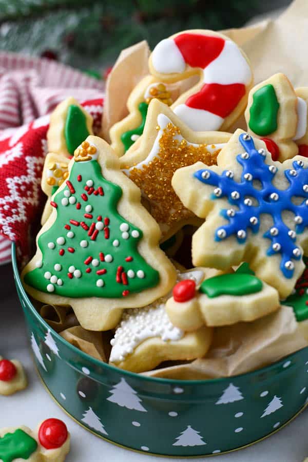 Decorated Christmas cookies in a festive tin.