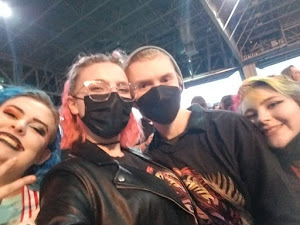 A photo of five people at an AJR concert.