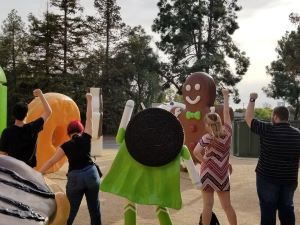 A photo of family members posing with a Google Android statue.