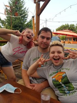 A photo of Kylie, a man, and her sister at a reataurant called Bahn Mi Up