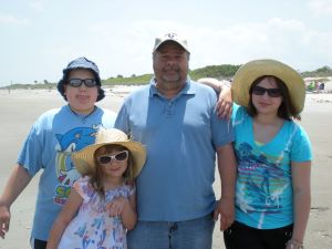 A photo of a family on a beach.