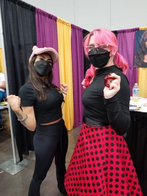 A photo of Christina Vee and Kylie posing like a superhero.