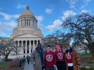 A photo of James, Ash, Kylie, and Reem at the Washington State Capitol.