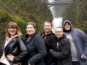 A photo of Kylie's family in front of a waterfall.