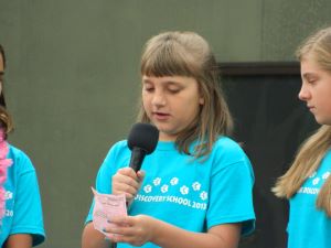 A photo of Kylie reading from a piece of paper.