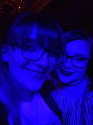 A photo of Kylie and her sister in blue lighting.