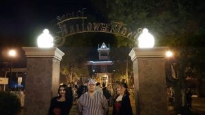 A photo of Kylie and her siblings under a 'Halloweentown' sign.