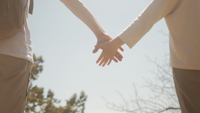 Man and woman holding hands