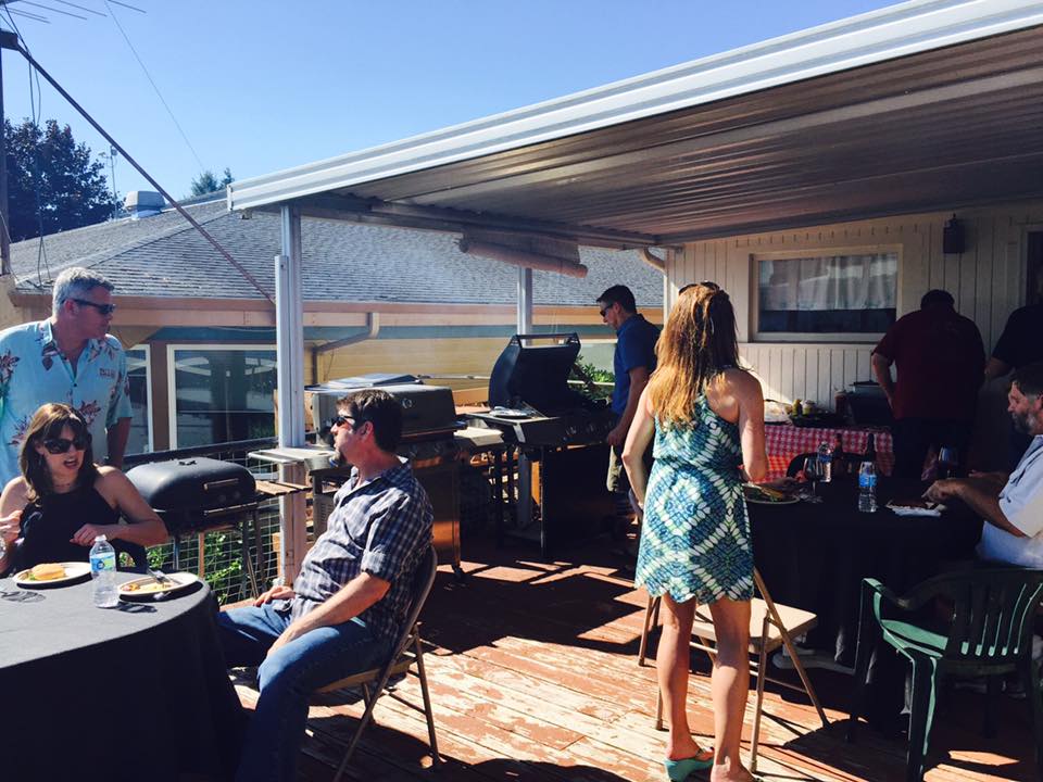 Guests gathered around a barbeque.