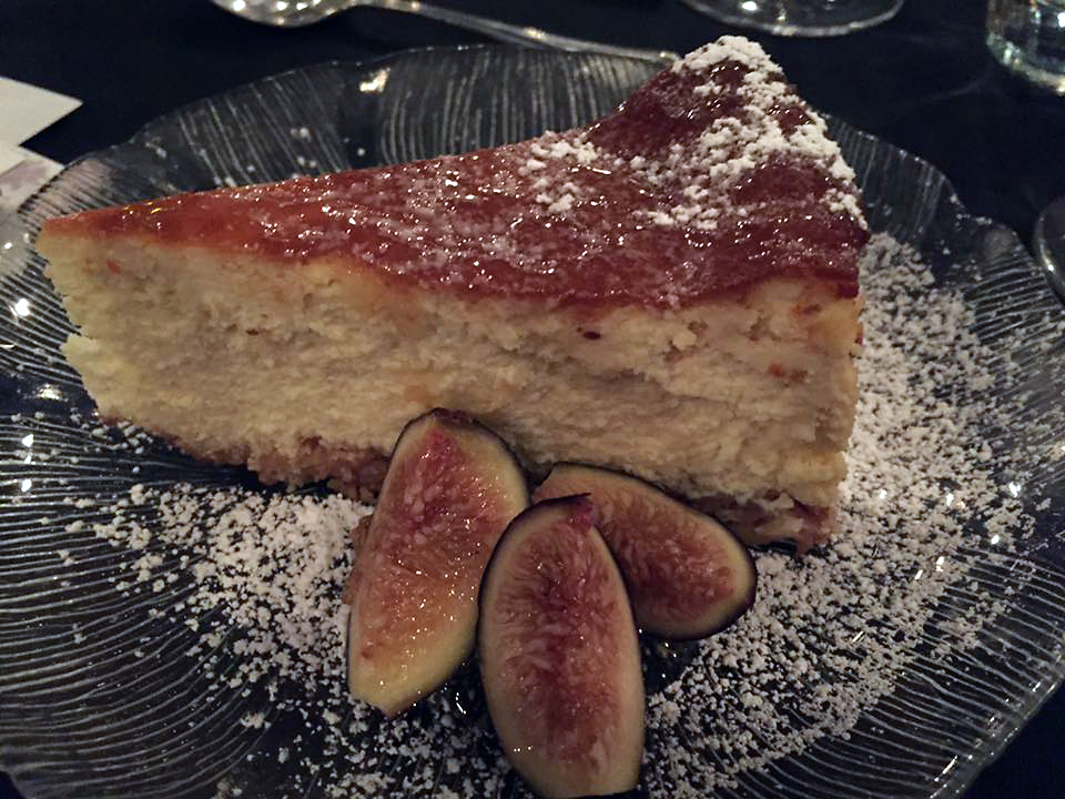 A slice of white cake served with fig slices.