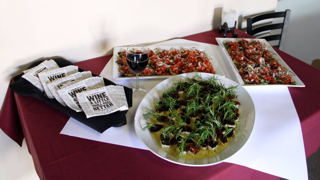 A table of bruschetta and cheese cubes ready for guests to enjoy.