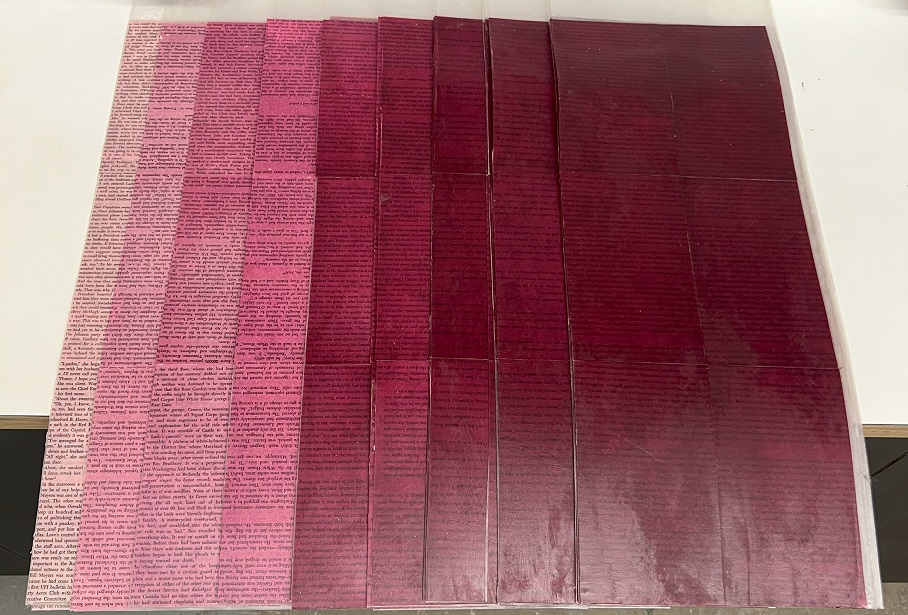 Book pages in a variety of purple dyes