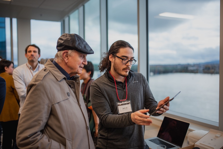 Two people looking at a tablet