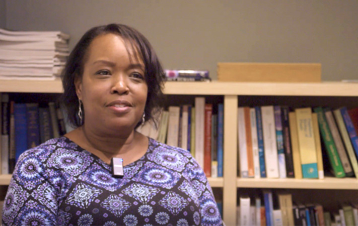 Interview headshot of a Professor within a lounge area of the Life Sciences building.