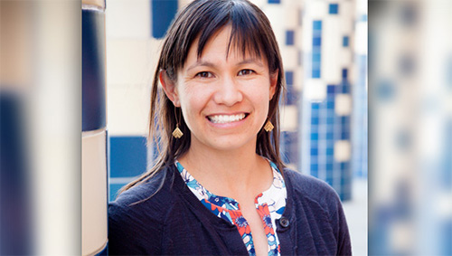 Portrait of Stephanie Porter, woman WSU Vancouver scientist, posed by the tile outside the WSU Vancouver VMMC building.