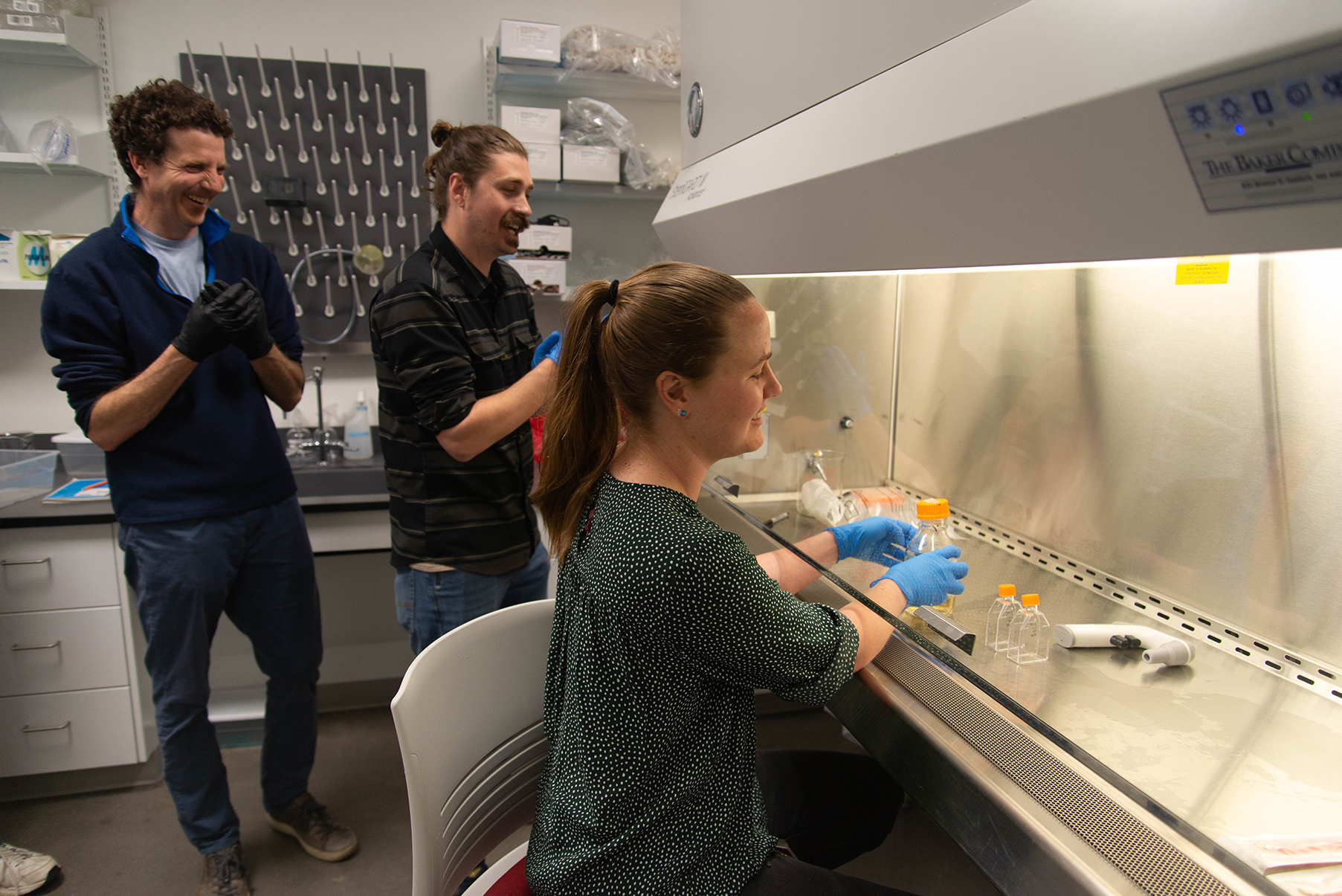 a WSU Vancouver scientist analyzing a group of fish tanks