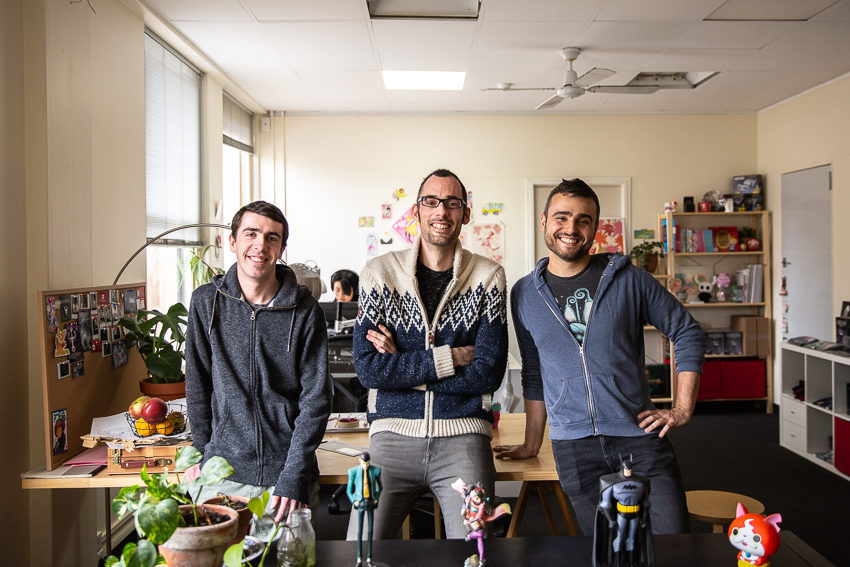 Photo of the three original members of team cherry happilly standing side by side in an office