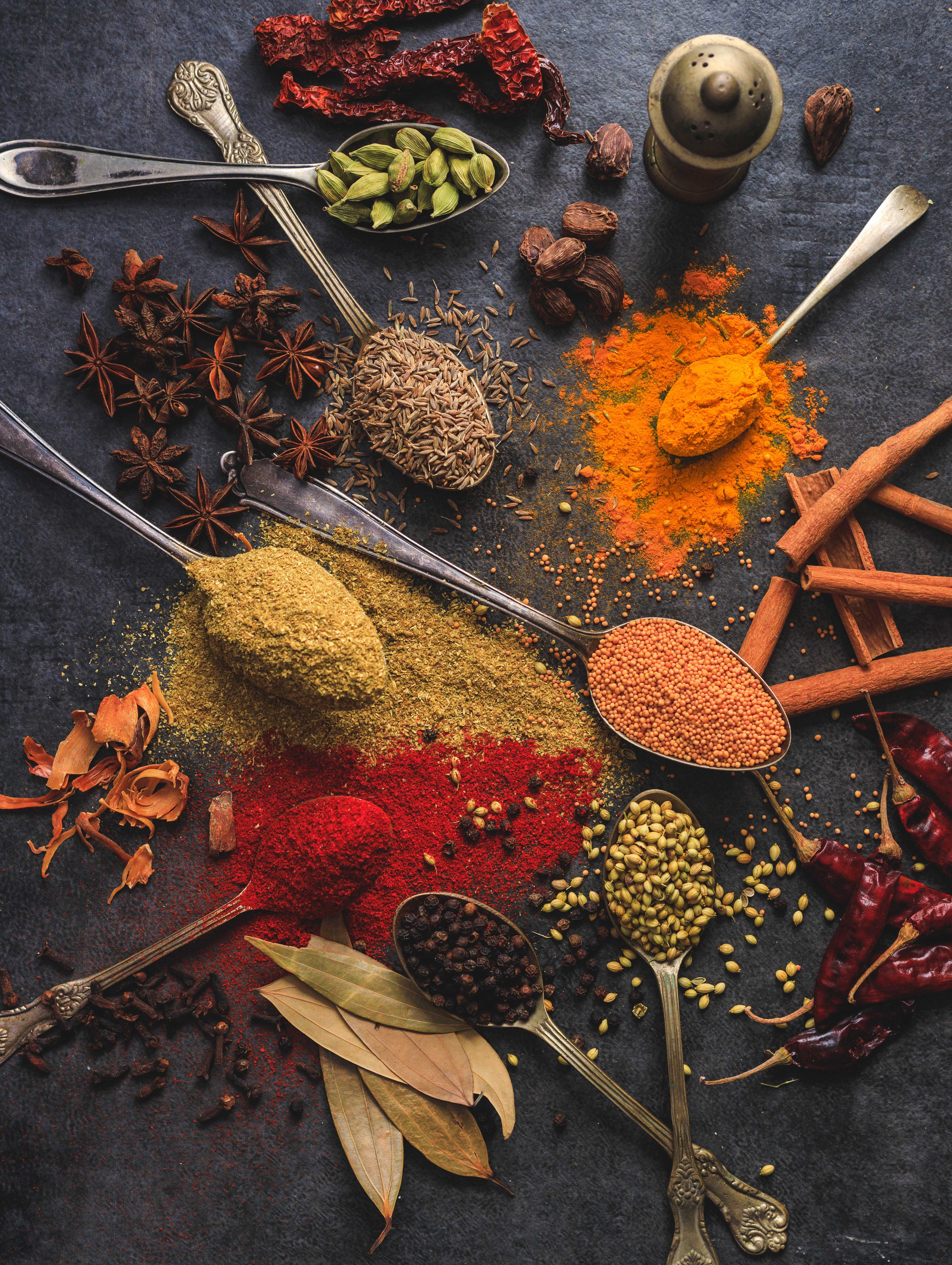 A variety of spices such as tumeric, cinnamon and bay leaves.